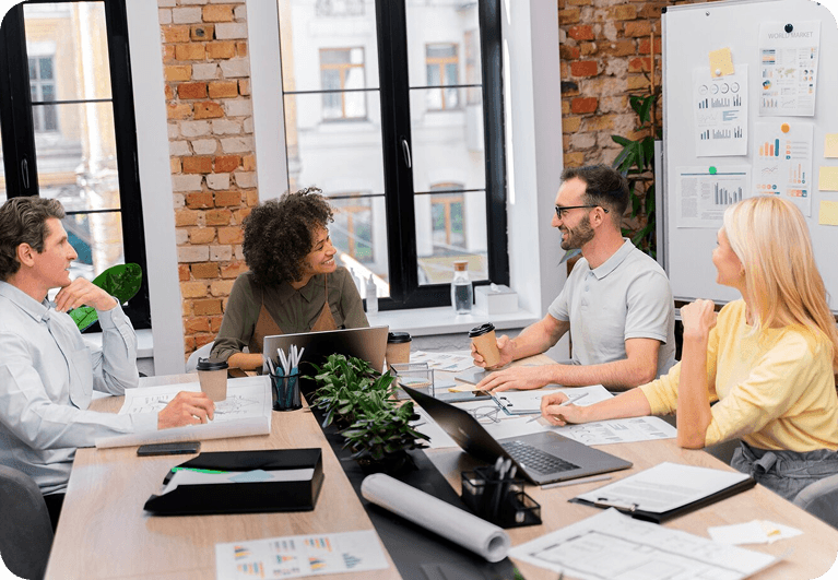 People collaborating in an office with brick walls