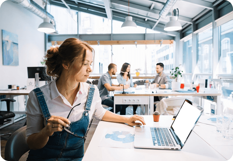 Woman working on laptop in modern office space
